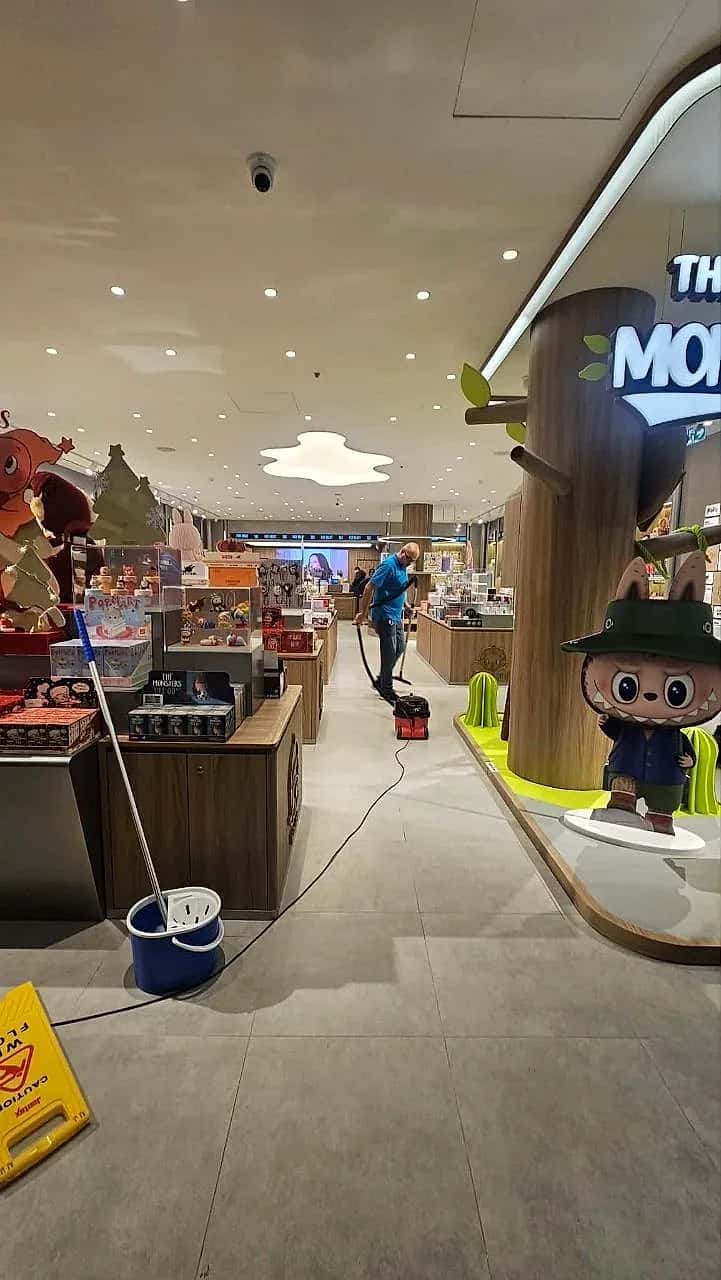A fitter mopping the finished floor of the Pop Mart store in Oxford at the end of the shift