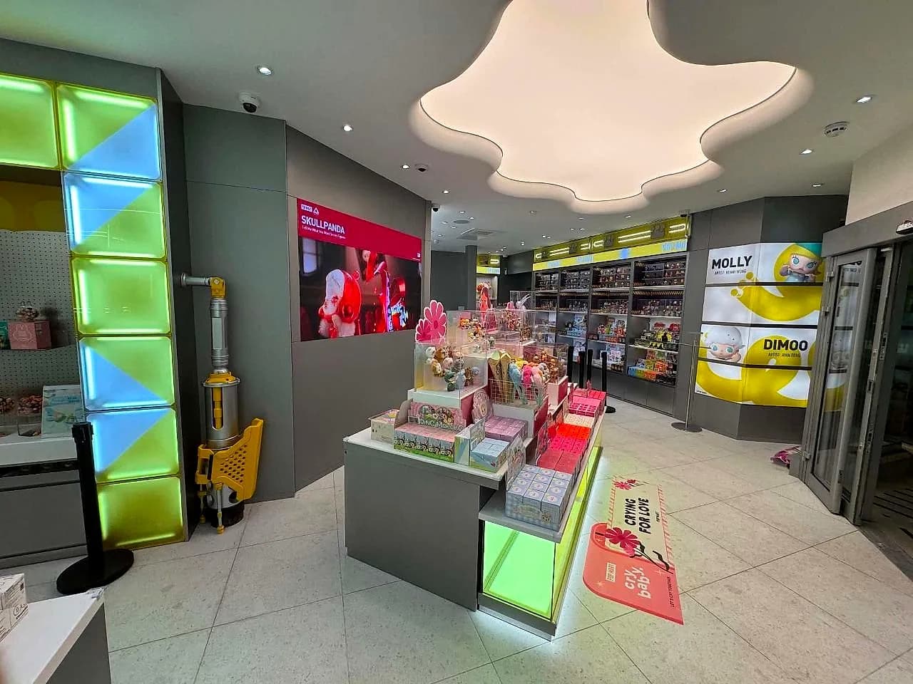 The cloud-shaped ceiling light over the shop floor of the Pop Mart store MO Team fitted out in Manchester city centre